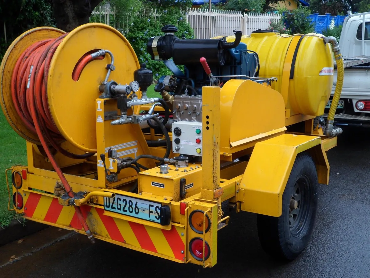 An ARPCO high-pressure jetting unit on its trailer: hose reel, water tank, engine-driven pump and control panel